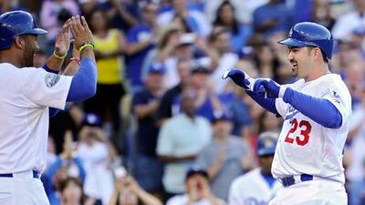 Adrian Gonzalez is congratulated by Matt Kemp after his three-run home run during his first innings for the LA Dodgers.