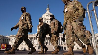 Members of the US National Guard walk the grounds of the US Capitol in Washington, DC, January 12, 2021. EPA