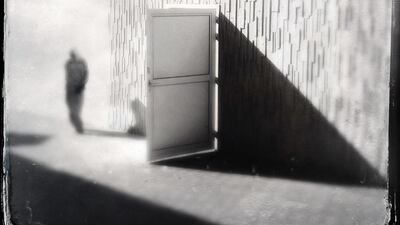 Worker walks under the bridge in Dubai Marina.