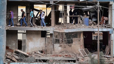 People search for belongings from homes in an apartment block in the Soublette neighbourhood in La Guaira, Venezuela, that was purportedly damaged during US military operations there. Getty