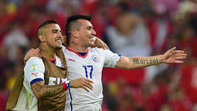 Chile's Arturo Vidal, left, and Gary Medel, right, celebrate following their team's win over Spain in the 2014 World Cup at the Maracana in Rio de Janeiro, Brazil. Martin Bernetti / AFP