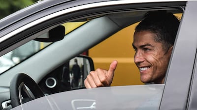 Juventus' Portuguese forward Cristiano Ronaldo gestures as he leaves in his car after attending training on May 19, 2020 at the club's Continassa training ground in Turin. AFP