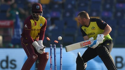 West Indies' wicketkeeper Nicholas Pooran watches after Australia's captain Aaron Finch is bowled by Akeal Hosein. AFP