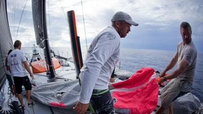 Abu Dhabi Ocean Racing's crew manoeuvre a sail about the small, narrow deck of 'Azzam' during Leg 2's voyage to Abu Dhabi.