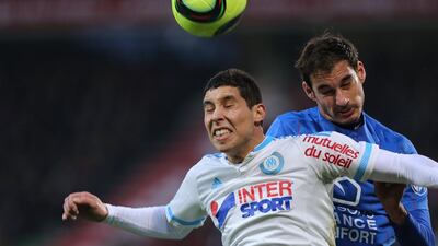 Marseille's Moroccan midfielder Abdelaziz Barrada, left, jumps for the ball with Caen's French midfielder Nicolas Seube during a match in January. Barrada is signing with Al Nasr ahead of the club's August Asian Champions League quarter-finals appearance. (AFP)