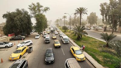 Vehicles drive along a road during a severe dust storm in Baghdad. AFP