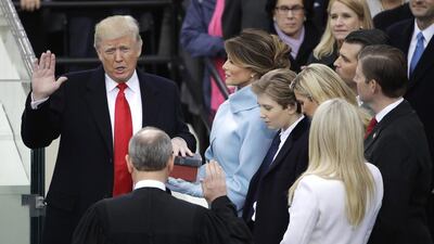Donald Trump is sworn in as the 45th president of the United States by chief justice John Roberts as his wife Melania looks on during the 58th presidential inauguration at the US Capitol in Washington, DC, on January 20, 2017. Matt Rourke / AP Photo