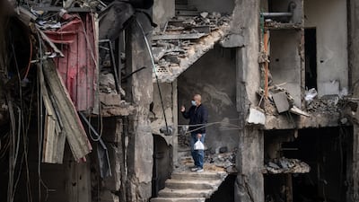 A man takes a photograph amid rubble in a building destroyed in an Israeli airstrike in Beirut. Getty Images