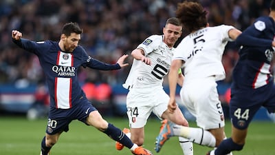 Paris Saint-Germain's Argentine forward Lionel Messi, left, fights for the ball with Rennes' French midfielder Benjamin Bourigeaud. PSG lost the match at the Parc des Princes Stadium in Paris on March 19, 2023 2-0. AFP