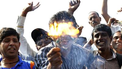 Indian cricket fans light fire crackers after the match at Wankhede Stadium to pay tribute to Sachin Tendulkar following his final match. Rajanish Kakade / AP Photo