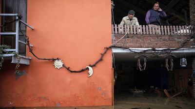 Two men stand on a balcony of a house as they look at the floods due to heavy rains in Moncalieri, near Turin. Flooding caused by torrential rain in northern Italy was feared to have claimed at least one victim after a man was swept away by a swollen river near Turin. Several hundreds of people had to be evacuated from their homes and many roads, schools and businesses were closed across the northwestern regions of Piedmont and Liguria as the River Po and its tributaries burst their banks in numerous places. AFP