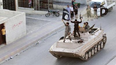 Militant Islamist fighters take part in a military parade along the streets of northern Raqqa province on June 30, 2014. (Reuters)