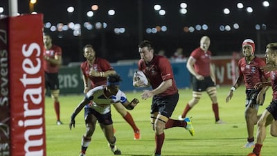 The Dubai Exiles, in red, ran out comfortable winners against Kandy but did not secure the required points to prevent the Abu Dhabi Harlequins from winning the Western Clubs Champions League. Antonie Robertson / The National