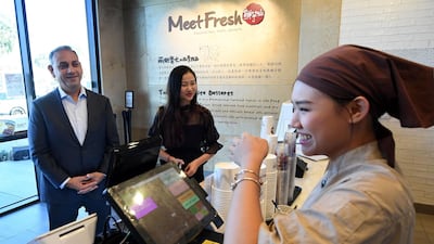 Democratic Party candidate Gilbert Cisneros (left) meets voters as he campaigns for the United States House of Representatives to represent California's 39th congressional district during the 2018 mid-term elections, in Rowland Heights, California. Cisneros who is a well-known philanthropist in the district served in the navy for 11 years before winning a Mega Millions lottery jackpot worth $266 million. AFP