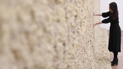A woman views Danish-Icelandic artist Olafur Eliasson's work 'Moss Wall' (1994). Photo: EPA