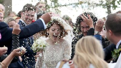 Actors Kit Harington and Rose Leslie react as they leave after their wedding ceremony, at Rayne Church, Kirkton of Rayne in Aberdeenshire, Scotland, Saturday June 23, 2018. The couple and guests arrived at Rayne Church, close to the 900-year-old Wardhill Castle in northeast Scotland, which is owned by Leslie’s family. Harington, wearing a morning suit, and Leslie, in a flowing ivory gown, smiled at members of the public who had gathered outside the church. Jane Barlow / PA via AP