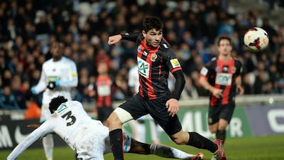 Nice forward Neal Maupay runs past Nicolas Nkoulou as he falls on Tuesday. Anne-Christine Poujoulat / AFP
