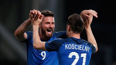 Olivier Giroud, left, was on the scoresheet twice while Arsenal and France teammate Laurent Koscielny also scored in the 3-0 win over Scotland. Thibault Camus / AP Photo