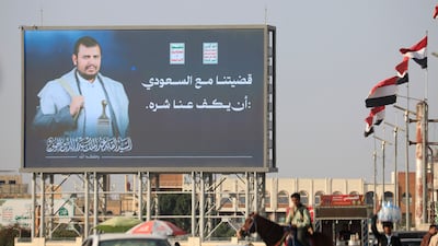 Yemeni flags (R) flutter a digital billboard features Houthi leader Abdul-Malik al-Houthi with a phrase reading in Arabic 'Our dispute with Saudi Arabia is that it stops its harm against us', on a street in Sana'a, Yemen, 11 October 2026. Yemen's Houthis have renewed warnings to airlines against using Saudi airports following a missile attack on Riyadh's King Khalid International Airport on 10 October 2026 that killed 12 people, including four Saudi nationals and eight foreign nationals, and forced the suspension of airport operations, according to Houthi military spokesman Yahya Sarea. EPA / YAHYA ARHAB