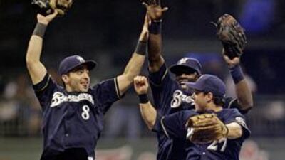 (From left) Milwaukee Brewers' Ryan Braun, Mike Cameron and Frank Catalanotto celebrate their win over the St Louis Cardinals.