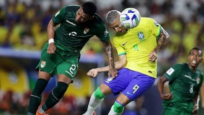 Brazil's Richarlison vies for the ball with Bolivia's Jairo Quinteros. Reuters