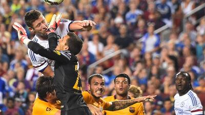 Chelsea’s Gary Cahill heads the ball past Barcelona goalkeeper Jordi Masip to score a late equaliser 2-2 in Tuesday’s pre-season tour match in Washington. Nicholas Kamm / AFP