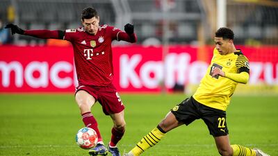Dortmund's Jude Bellingham in action against Bayern's Robert Lewandowski. EPA