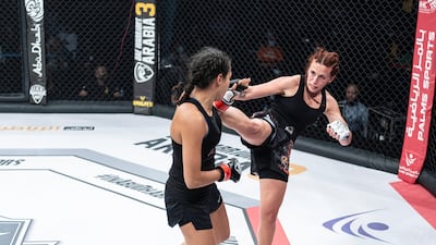 Lina Fayyad lands a high kick on Sophia Haddouche in the UAE Warriors 19 Arabia 3 at the Jiu-Jitsu Arena. Courtesy UAE Warriors