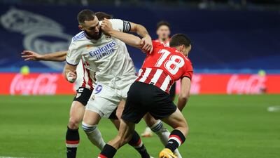 Karim Benzema tussles with Athletic defender Oscar de Marcos. EPA
