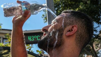 A man pours water on his head to cool off as the temperature hits 44°C in Turkey in August 2023. Getty Images