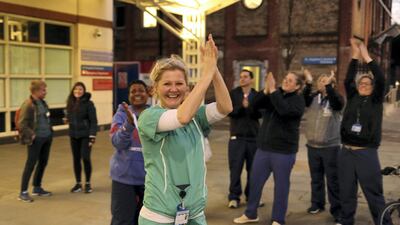 NHS workers applaud on the streets outside Chelsea and Westminster Hospital during the Clap for our Carers campaign in support of the NHS as the spread of the coronavirus disease (COVID-19) continues, London, Britain, Reuters