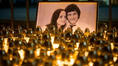 Light tributes placed during a silent protest in memory of murdered journalist Jan Kuciak and his girlfriend Martina Kusnirova, seen in photo, in Bratislava, Slovakia, on Wednesday, February 28, 2018. AP