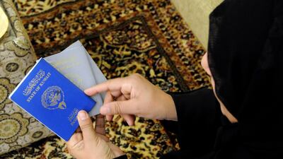 In Sulaibiya, Kuwait, a mother from a 'bidoon' family displays the two types of Kuwaiti passports. Gustavo Ferrari / The National