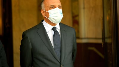 Iraqi Prime Minister Mustafa Al Kadhimi wears a protective face mask, following the outbreak of Covid-19 as he stands at the prime minister's office in Baghdad, Iraq on June 4. Reuters.