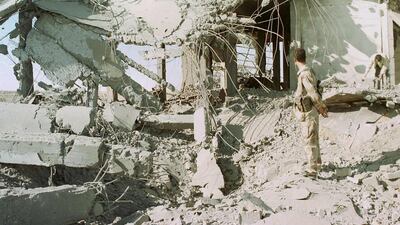 December 13, 2001: A Palestinian police officer inspects the rubble of a building at the Gaza international airport in Rafah after Israeli raids. Israeli warplanes bombarded Palestinian security buildings in the Gaza Strip and West Bank in swift revenge during the second intifida AFP Photo