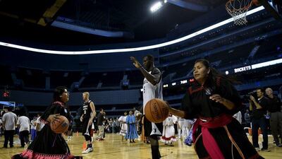 Gorgui Dieng of the Minnesota Timberwolves conducts a drill with a player from the Tarahumara women's basketball team on Tuesday in Mexico City. Yuri Cortez / AFP