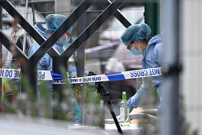 Forensics officers investigate a suspected firebomb outside Finchley Reform Synagogue. Getty Images
