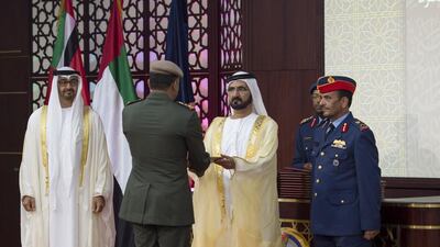 Sheikh Mohammed bin Rashid, Vice President and Ruler of Dubai presents a certificate to a graduate during the 2015-2016 UAE National Defense College graduation ceremony. Rashed Al Mansoori / Crown Prince Court — Abu Dhabi