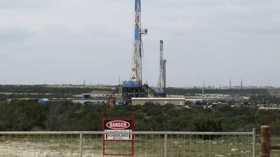 Above, rigs contracted by Apache drill for crude oil locked tight in shale in West Texas. Terry Wade / Reuters