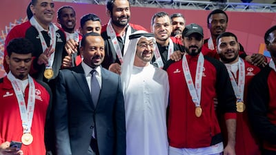 Sheikh Mohamed bin Zayed and Mr Ahmed stand for a photograph with Special Olympics World Games Abu Dhabi 2019 athletes.