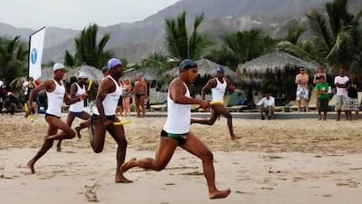 Lifeguards race across the beach at Le Meridien Al Aqah resort in Fujairah yesterday. Teams from 20 different UAE hotels and resorts compete against each other at the 7th annual UAE Lifeguard Championships.