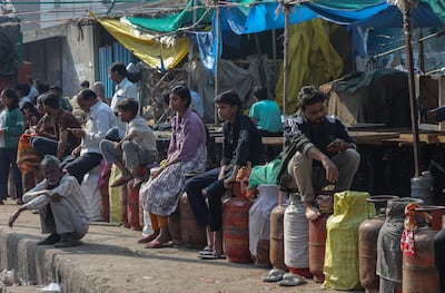 People queue to refill their empty liquefied petroleum gas (LPG) cylinders near a gas agency office in Noida, Uttar Pradesh, India. EPA