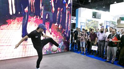 A freestyle football player at the Turkish Airlines stand wows the crowd with ball-handling tricks. Reem Mohammed / The National