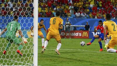Alexis Sanchez shoots to score Chile's first goal in their 3-1 win over Australia on Friday night in 2014 World Cup Group B play in Cuiaba, Brazil. Eddi Keogh / Reuters