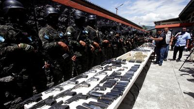 Members of the Military Police of Public Order present bullets, magazines and weapons after the Honduras Armed Forces took over the control of the prisons nationwide. Reuters
