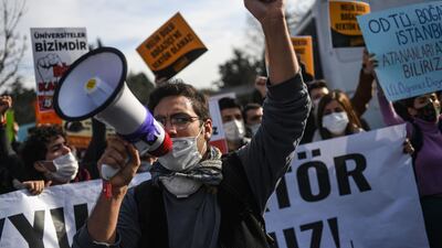 Students chant slogans and hold placards in front of the Bogazici University. AFP