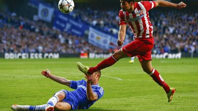 Atletico Madrid forward Diego Costa is blocked by Chelsea defender Gary Cahill during their Champions League semi-final match on Wednesday. Eddie Keogh / Reuters / April 30, 2014