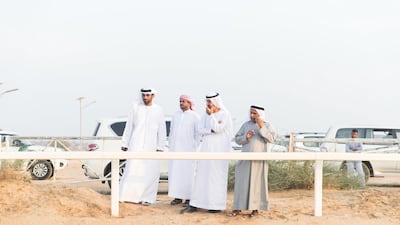 Spectators watch the camel marathon at Dubai International Endurance City on Sunday. Reem Mohammed / The National