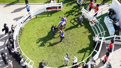 Jockey Adam Kirby celebrates in the winners enclosure after winning the Derby on Adayar. PA