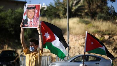 A protester holds a poster of Jordan's King Abdullah as he takes part in a human chain during a sit-in against the annexation of parts of the West Bank by Israel, in Amman, Jordan, on June 27, 2020. Reuters